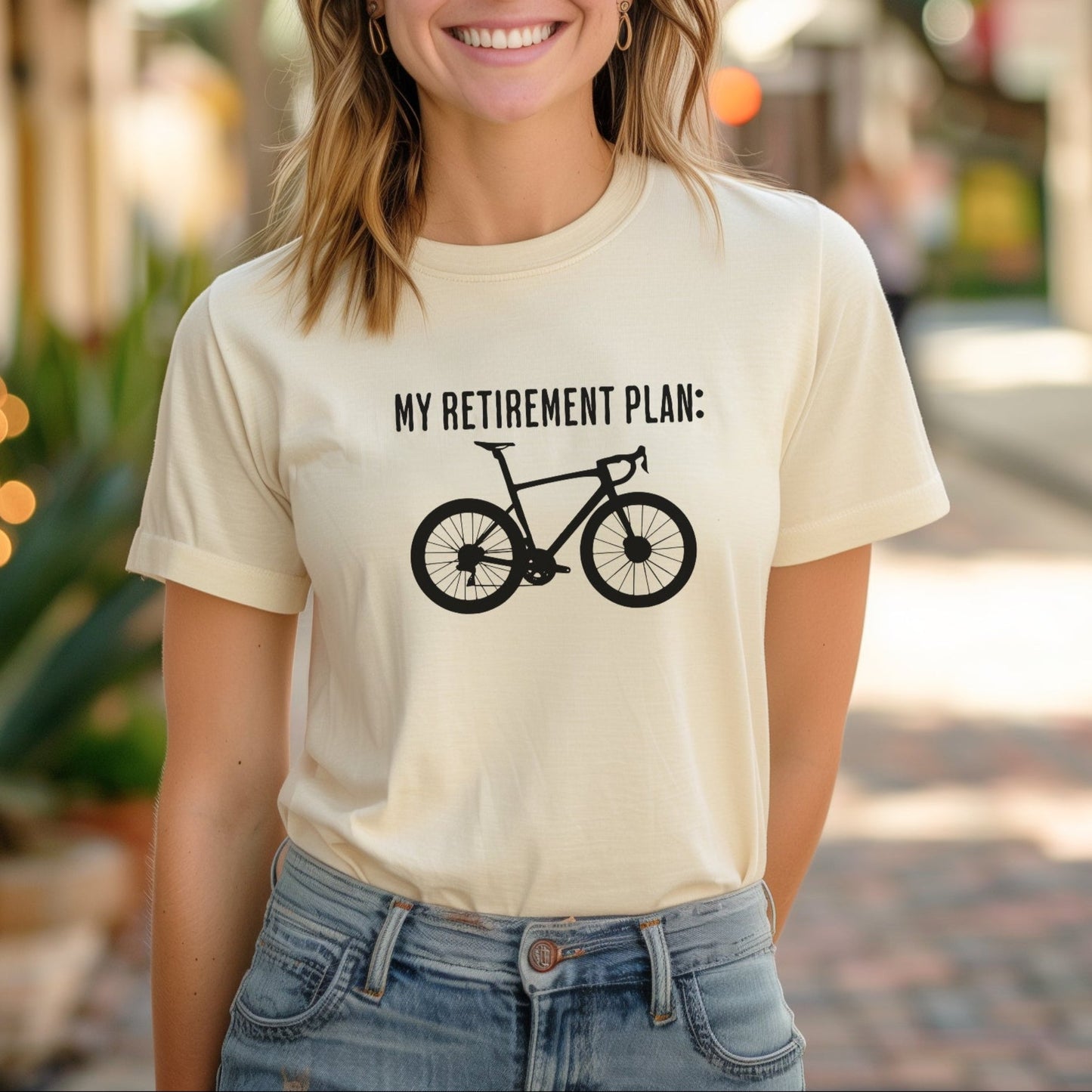 Woman wearing a t-shirt with a bicycle graphic and text on a street background