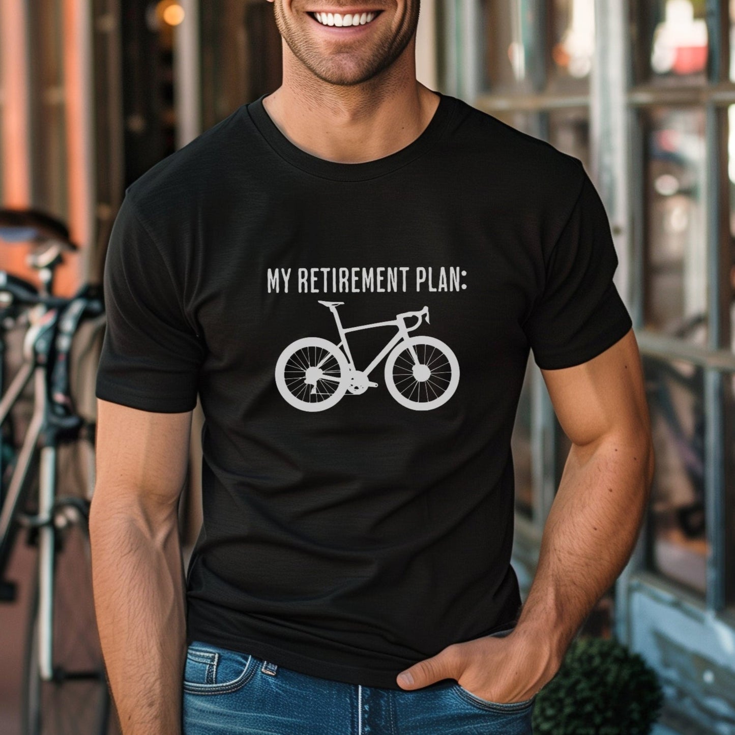 Man wearing a black t-shirt with a bicycle graphic and text, standing outdoors.