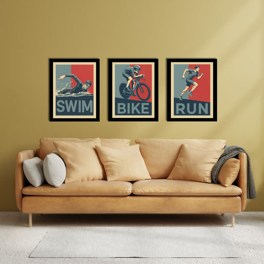 Three framed posters labeled 'Swim', 'Bike', and 'Run' above a beige sofa with decorative pillows.