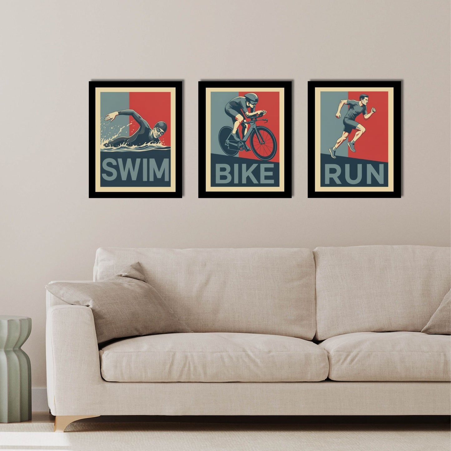 Three framed posters of swimmer, cyclist, and runner on a wall above a sofa.