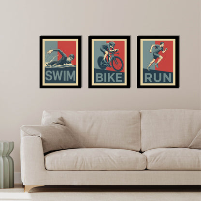 Three framed posters of swimmer, cyclist, and runner on a wall above a sofa.