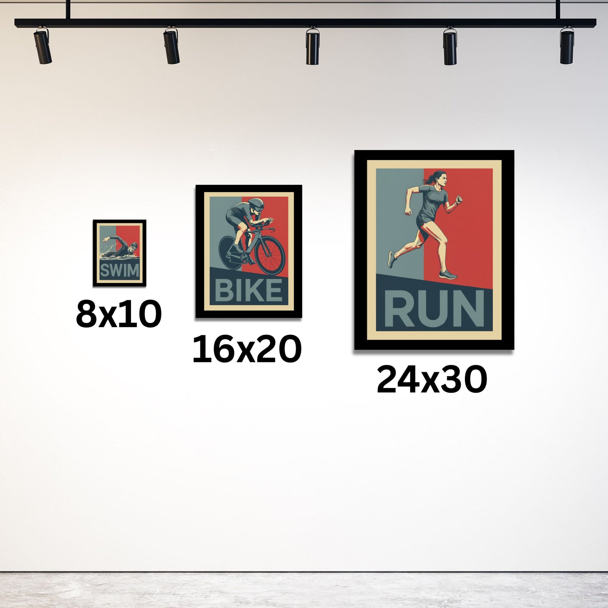 Three framed posters of a swimmer, cyclist, and runner with size labels on a white wall.