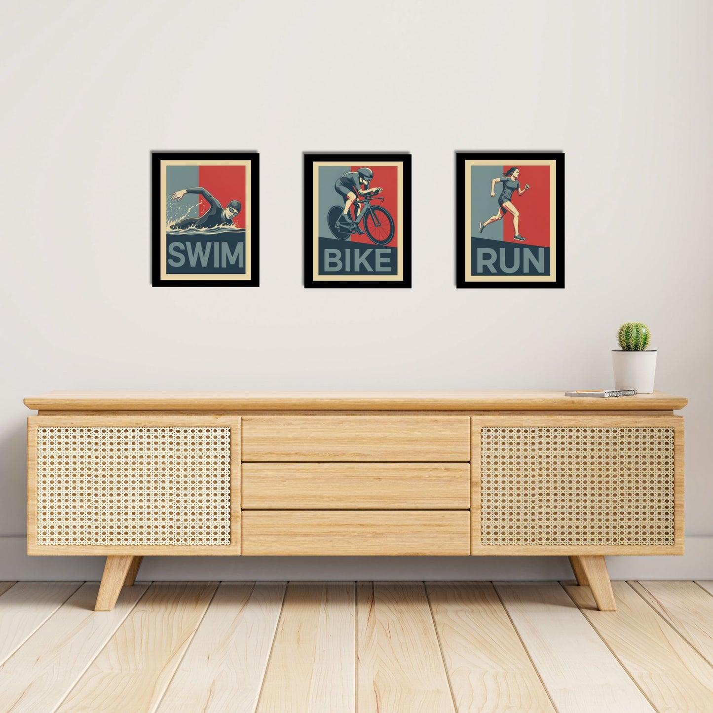 Wooden sideboard with framed posters labeled 'Swim', 'Bike', and 'Run' on a light gray wall.