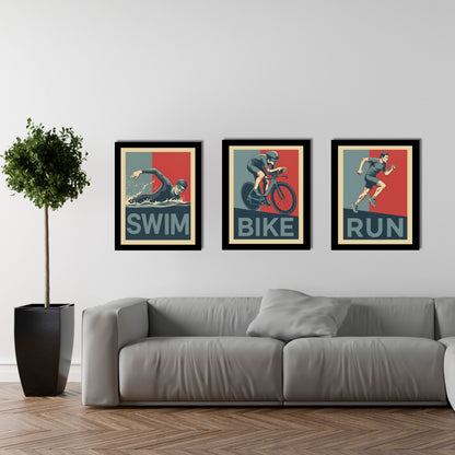 Three framed posters of a swimmer, cyclist, and runner on a wall above a sofa.