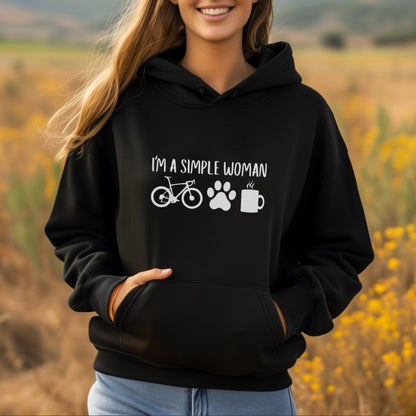 Woman wearing a black hoodie with text and symbols in a field