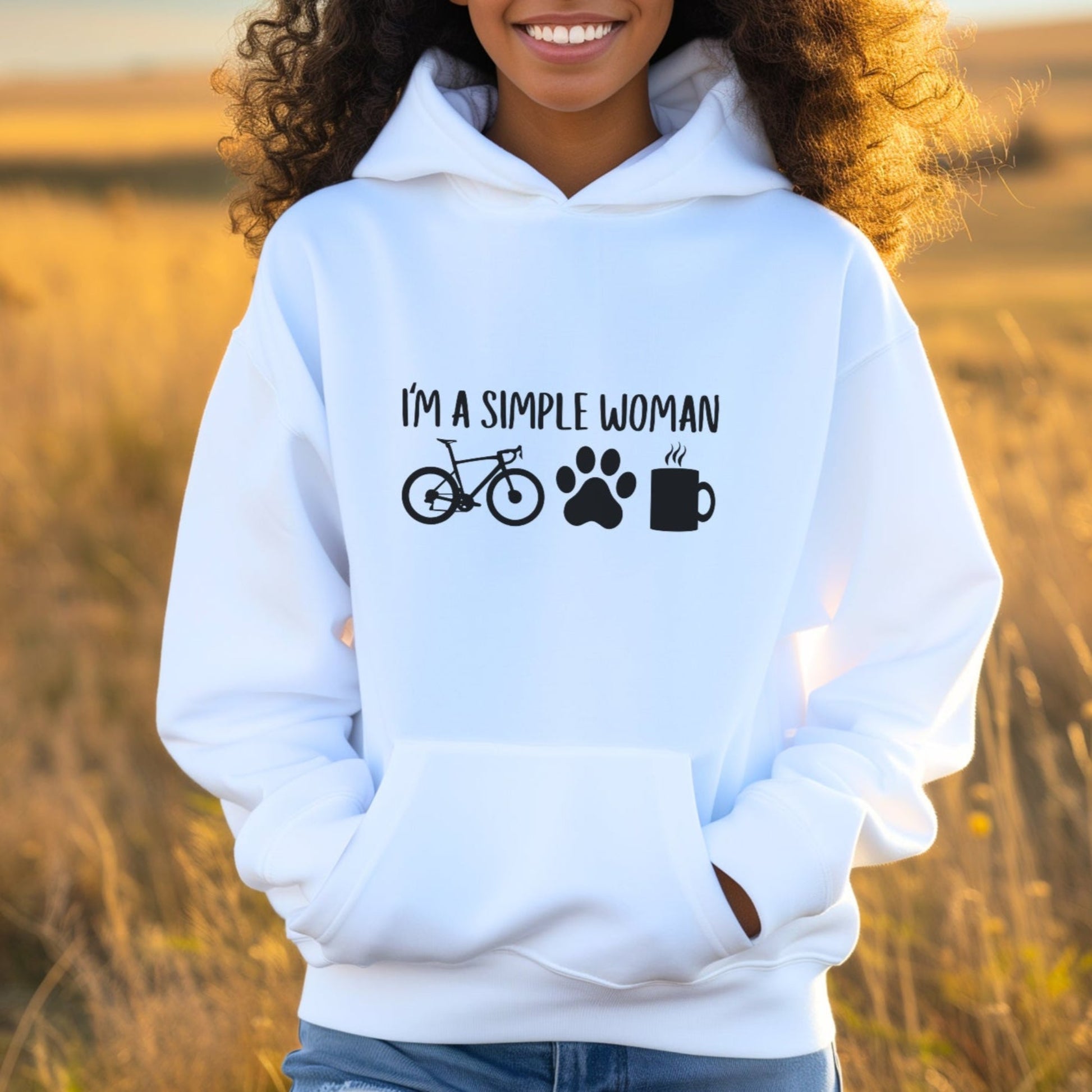 Woman wearing a white hoodie with text and icons in a field