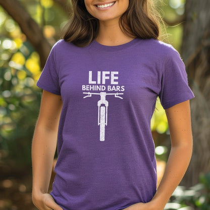 Person wearing a purple t-shirt with 'Life Behind Bars' graphic outdoors