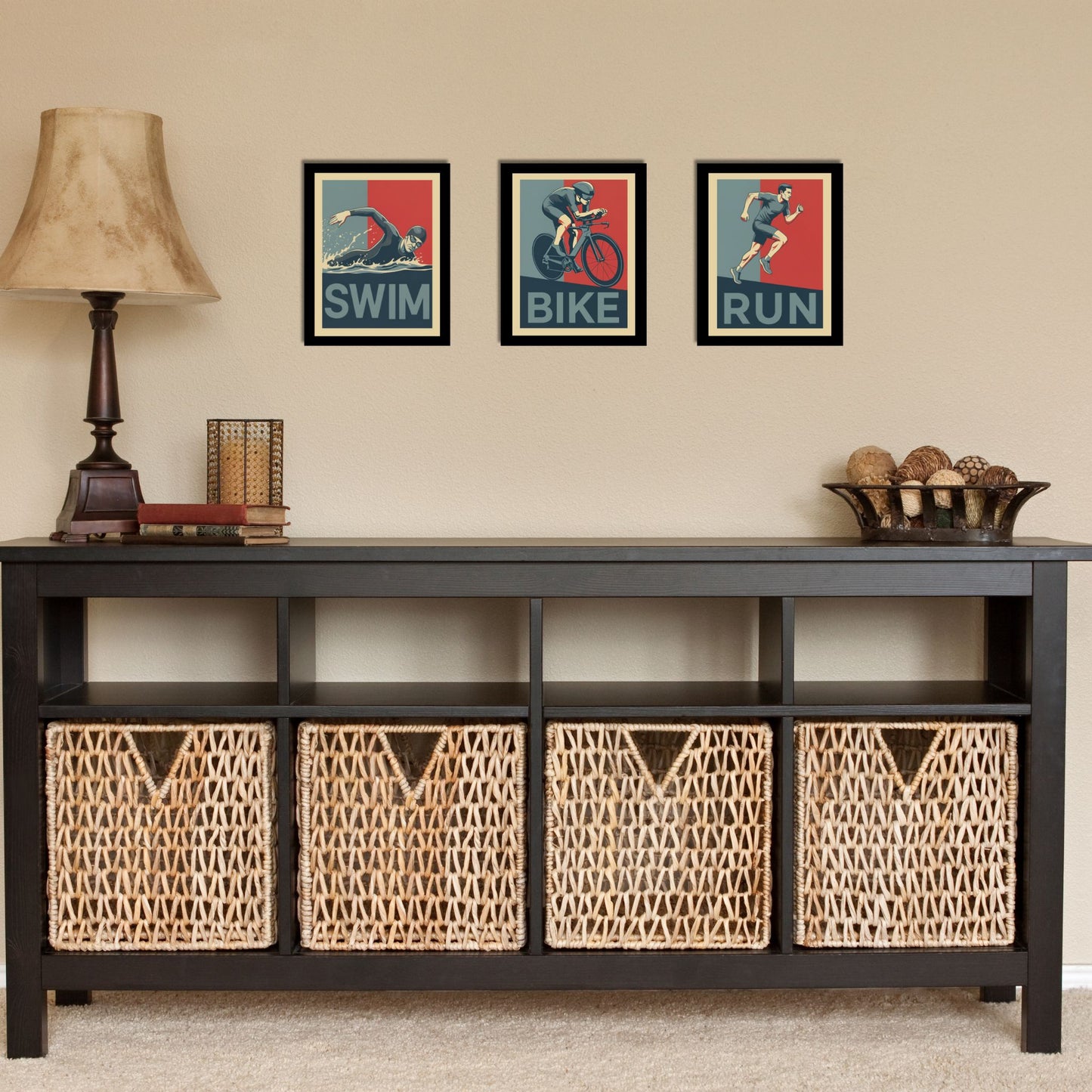 Black console table with wicker baskets and framed artwork on a beige wall.