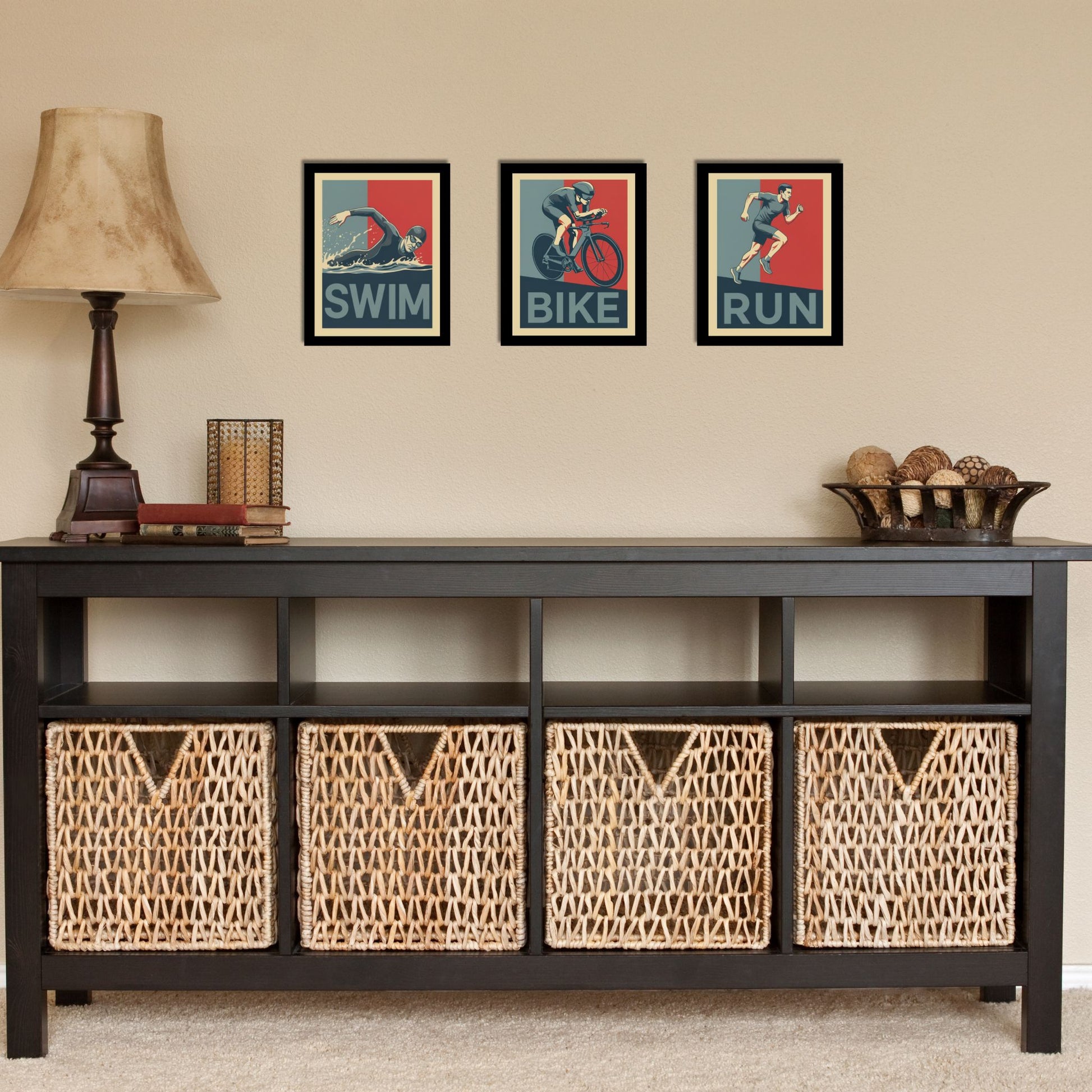 Black console table with wicker baskets and framed artwork on a beige wall.